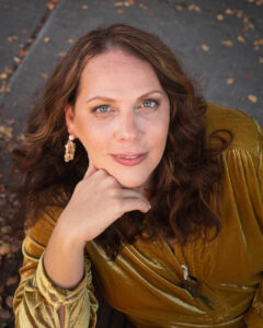 Headshot of Andrea Arth in a fabulous gold dress women we know over 40 SSM Creative Collective